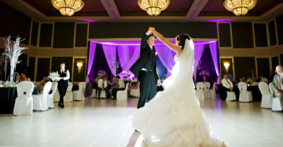 Wedding Couple Dancing in the Large Ballroom